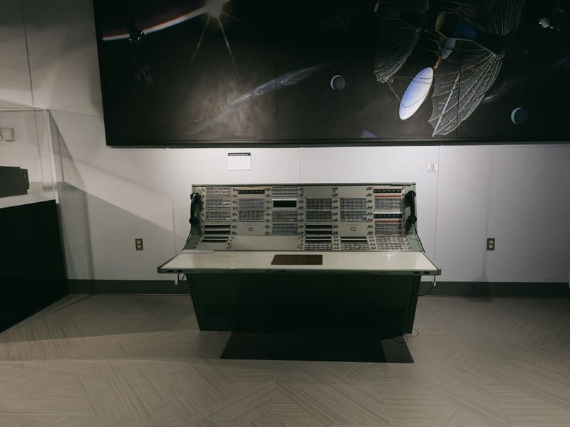 Large communications console below a space-themed wall mural