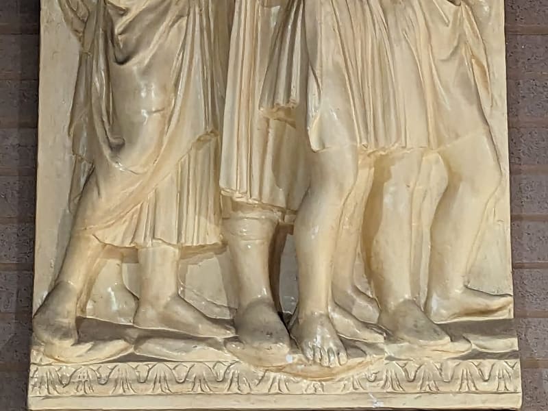 Carved stone relief of a group of singing figures