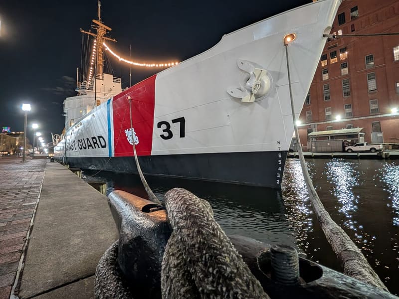 The Coast Guard cutter USCGC Taney moored in the Inner Harbor at night