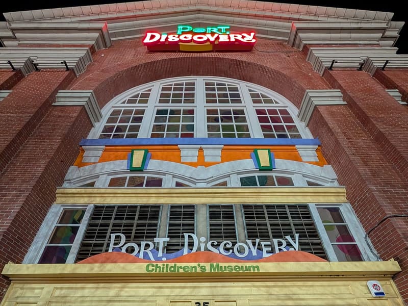 The colorful entrance of Port Discovery Children's Museum at night