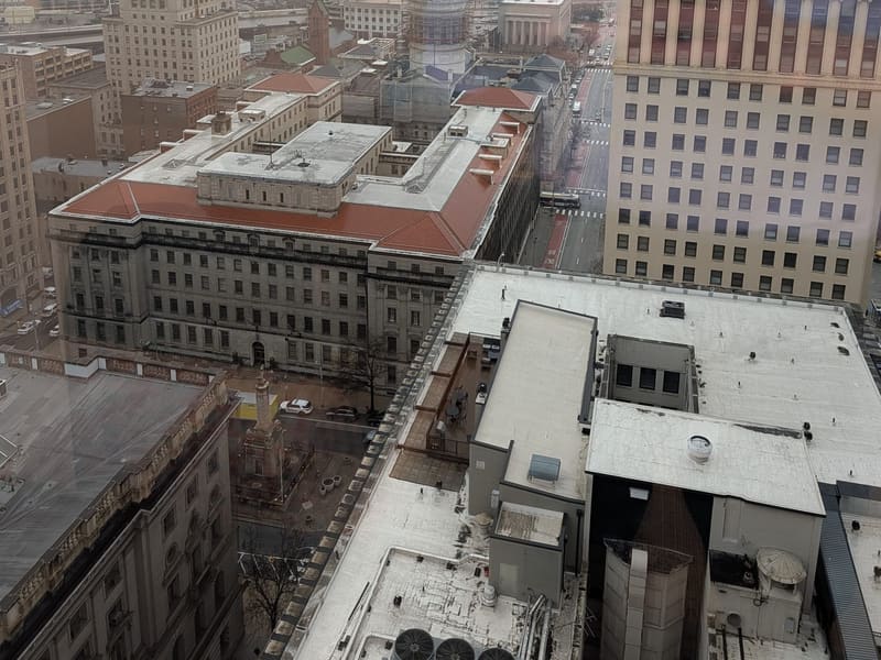 Aerial view of downtown Baltimore in fog, the gilded courthouse dome at center