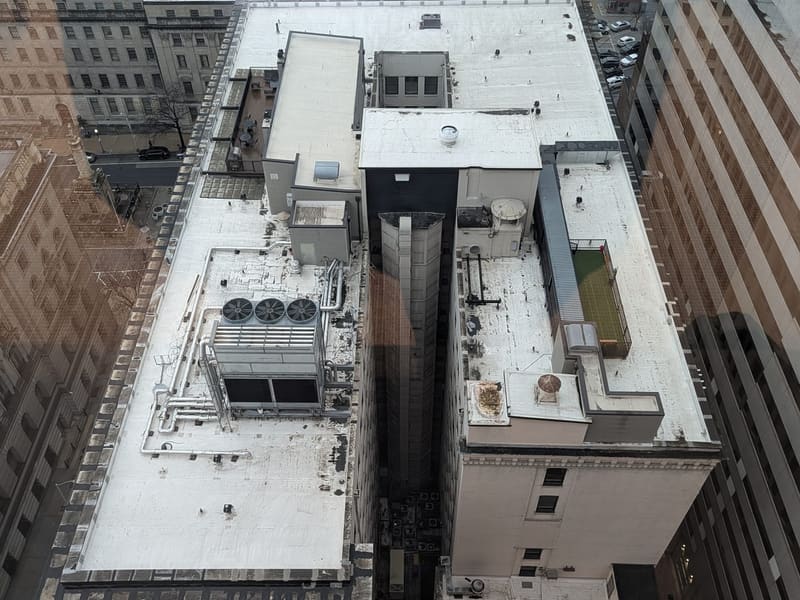 Looking straight down between downtown rooftops from a high floor