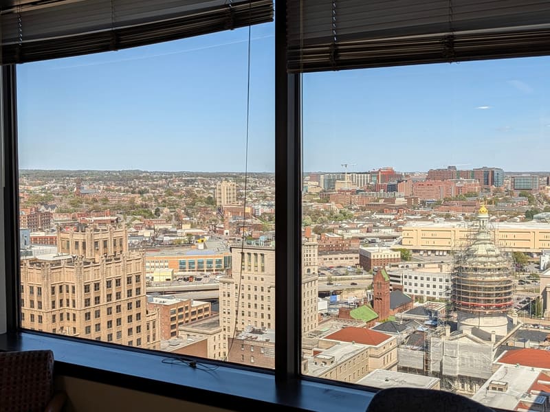 City skyline and the courthouse dome seen through a high office window