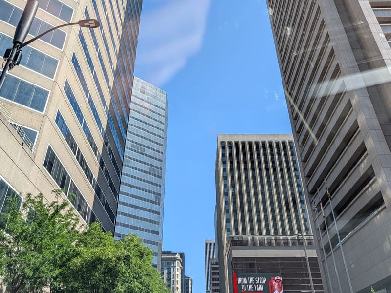 Downtown office towers rising into a clear blue sky