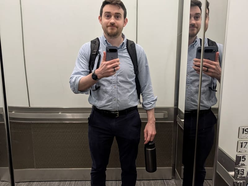 Brian Thackston taking a mirror selfie in an office elevator
