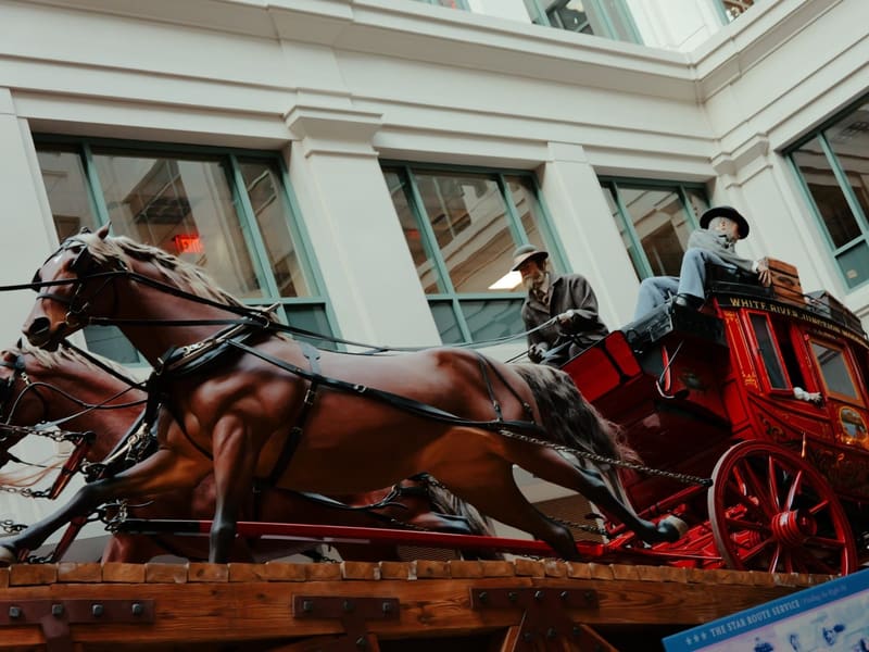 A red Western stagecoach and horse team at the National Postal Museum