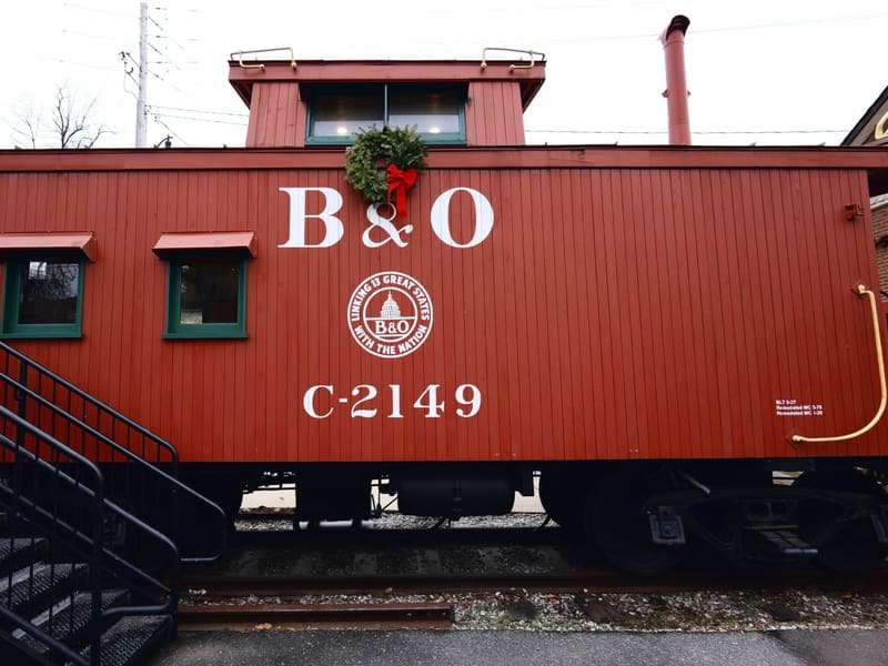 Restored red B&O caboose C-2149 with a holiday wreath