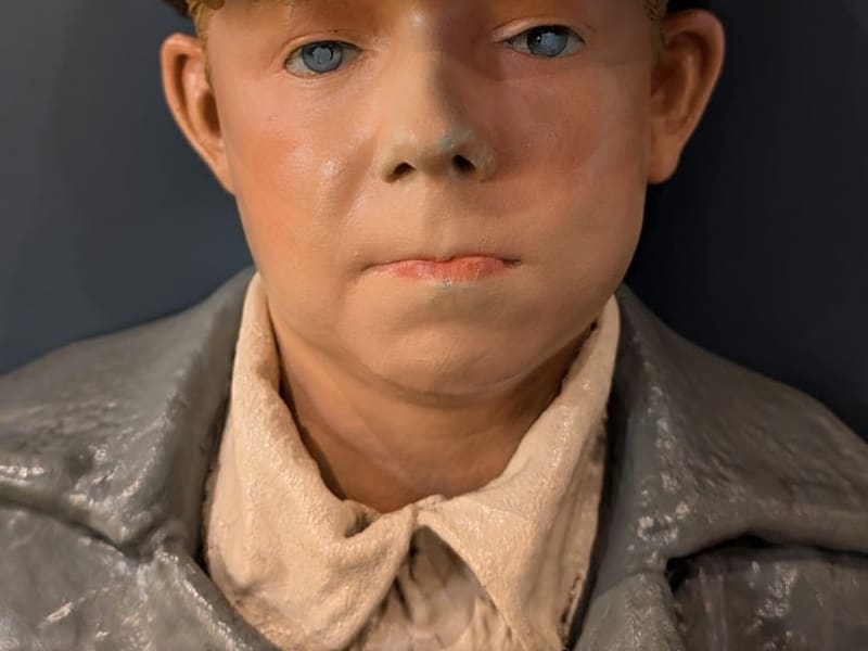 Museum mannequin of a young breaker boy in a flat cap
