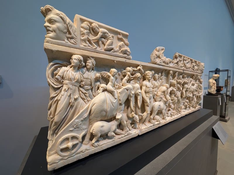 An elaborately carved Roman marble sarcophagus on display at the Museum of Fine Arts