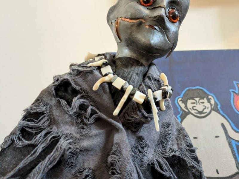 An eerie gray ghoul figure in a tattered cloak at the Cryptozoology Museum