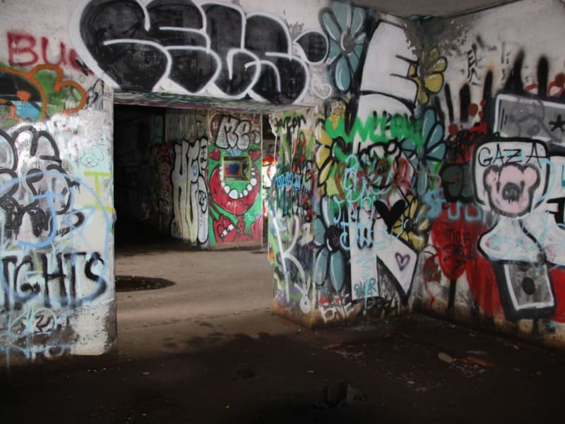 A graffiti-covered abandoned concrete structure