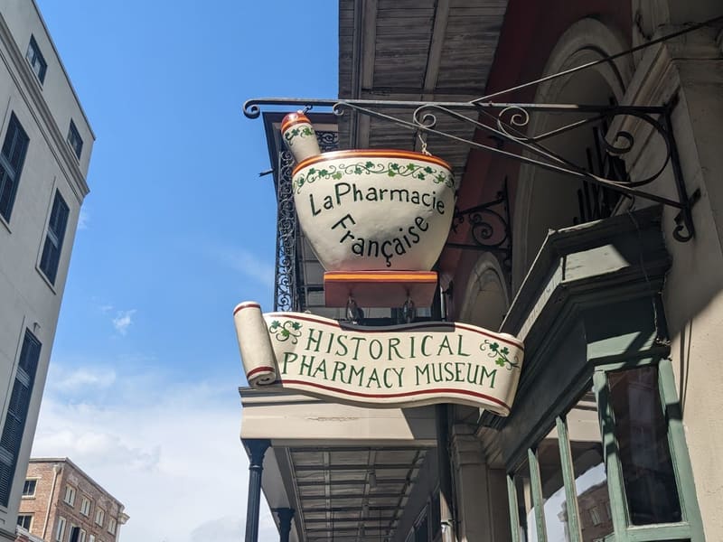 The hanging mortar-and-pestle sign of La Pharmacie Francaise, the New Orleans Pharmacy Museum