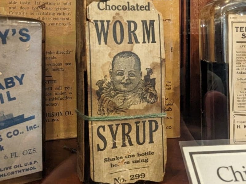 A vintage 'Chocolated Worm Syrup' patent-medicine bottle at the New Orleans Pharmacy Museum