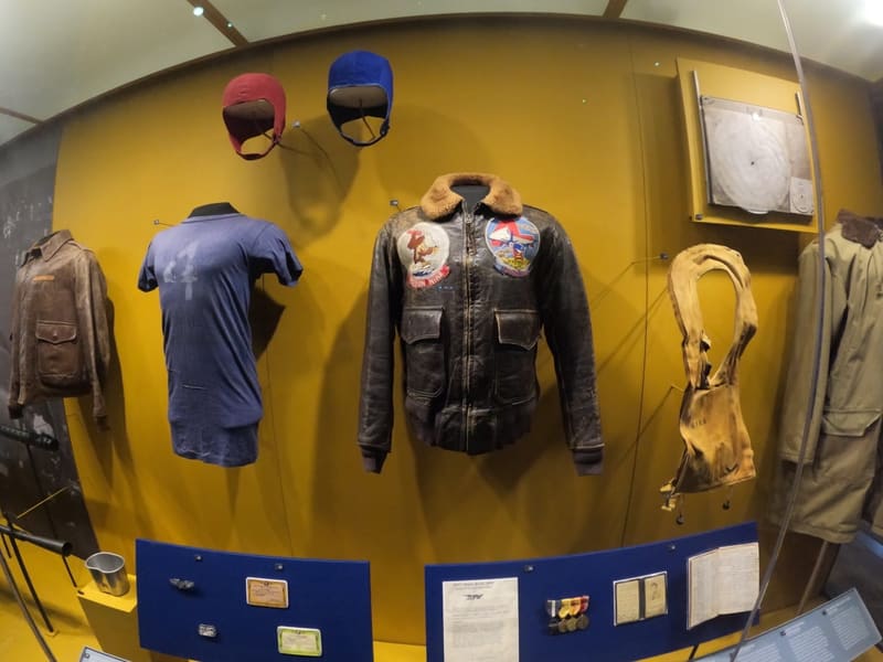 A display of worn WWII leather flight jackets and helmets at the National WWII Museum