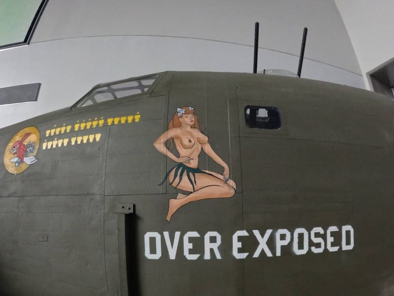 Restored B-17 nose art 'Over Exposed' featuring a hand-painted vintage pin-up at the National WWII Museum