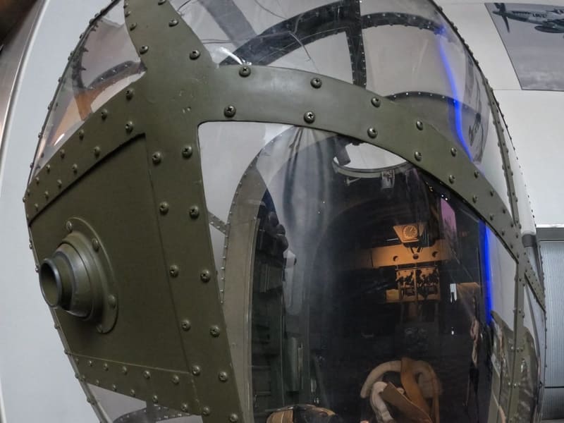 The riveted glass nose cone of a WWII bomber on display at the National WWII Museum