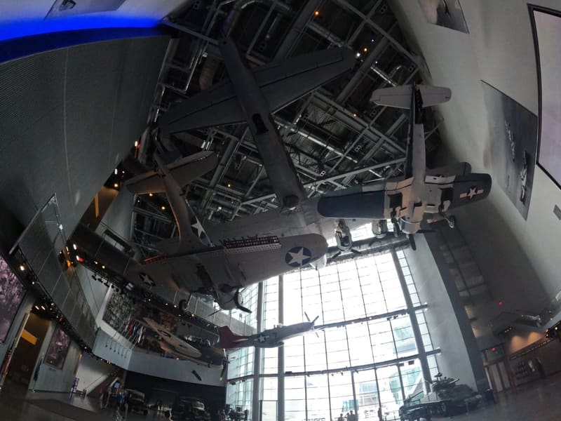 Looking up at WWII aircraft suspended from the ceiling of the museum's atrium