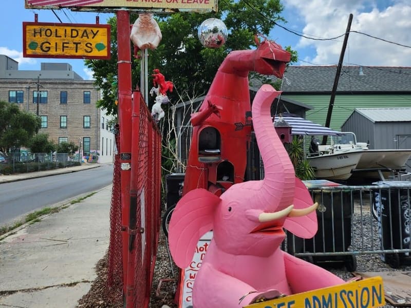 The 'Bywater Storage / Dr. Bob' folk-art sign and a pink elephant sculpture outside the studio