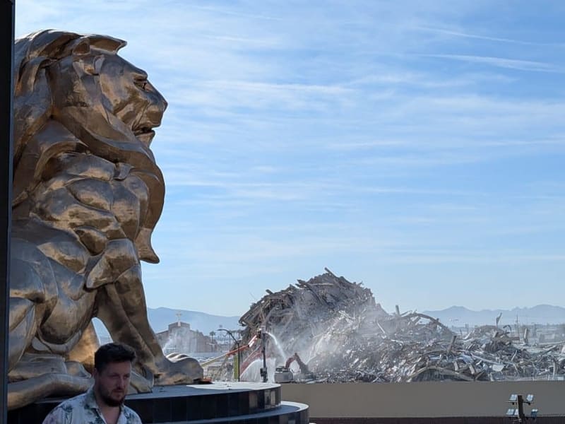 The MGM Grand's golden lion statue with the demolished Tropicana being cleared in the distance