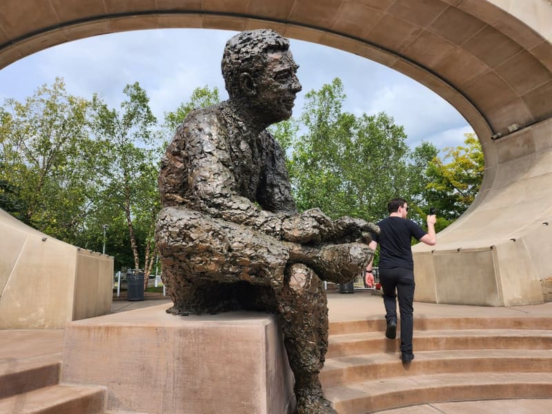 The bronze Mr. Rogers statue at the Tribute to Children memorial