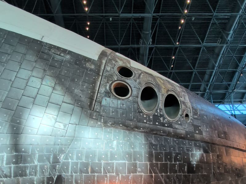 Walking past the Space Shuttle Discovery and aircraft in the hangar