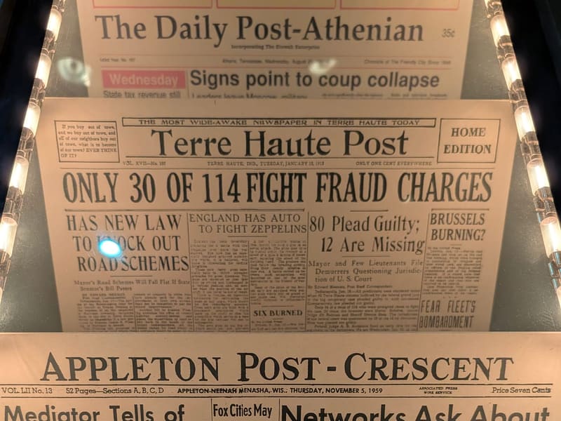 A display of vintage newspaper front pages about mail fraud
